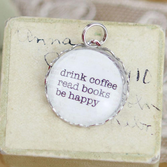 round jewelry charm that says Drink Coffee Read Books Be Happy